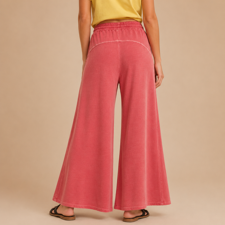 Person wearing heather-red wide-leg pants on a beige background