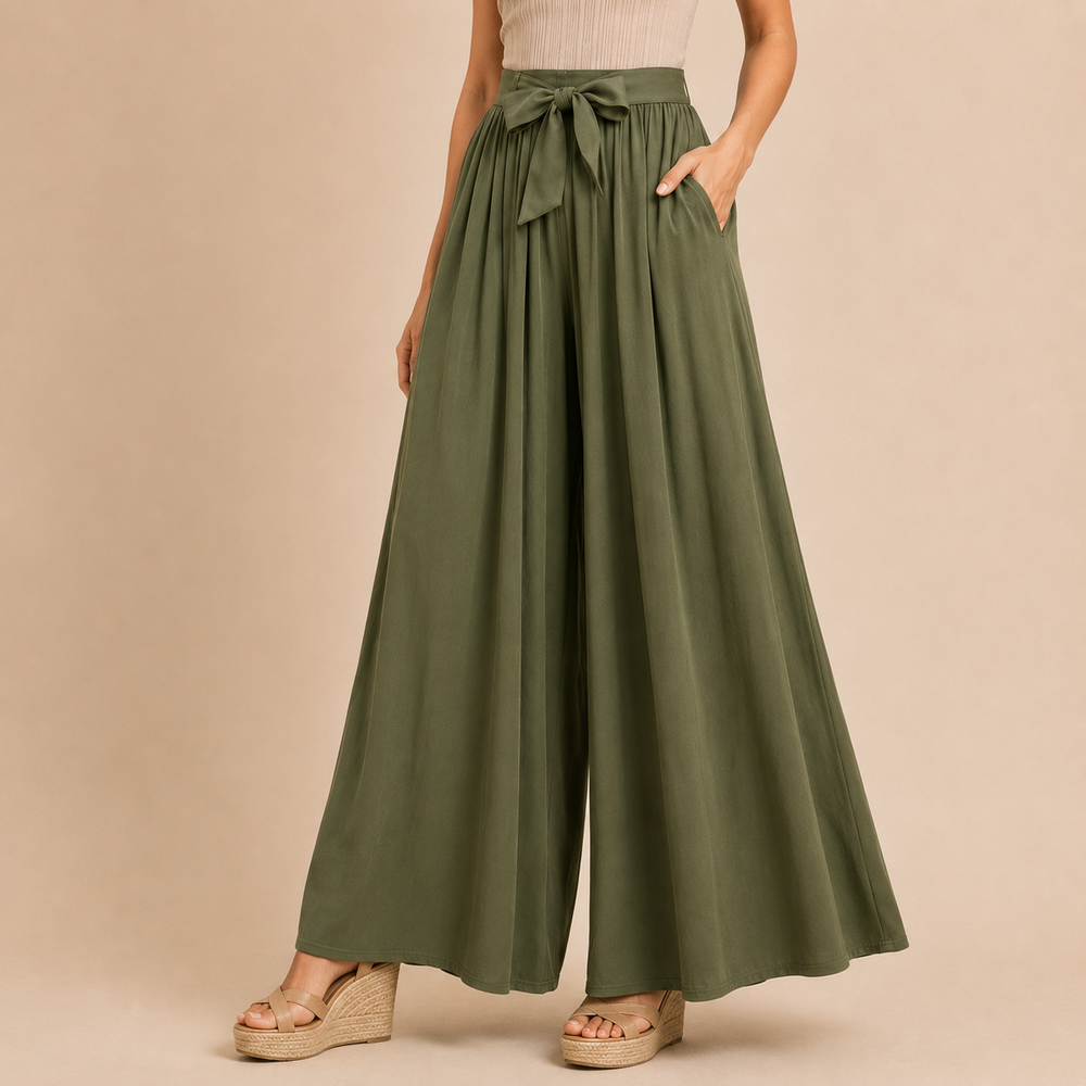 Green wide-leg pants with a tie waist worn by a person on a beige background