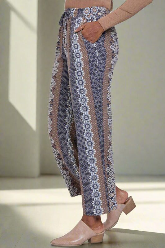 Patterned pants worn by a person on a white background