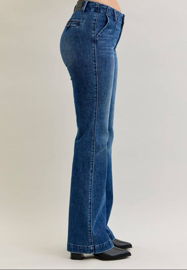 Blue jeans being worn on a plain background