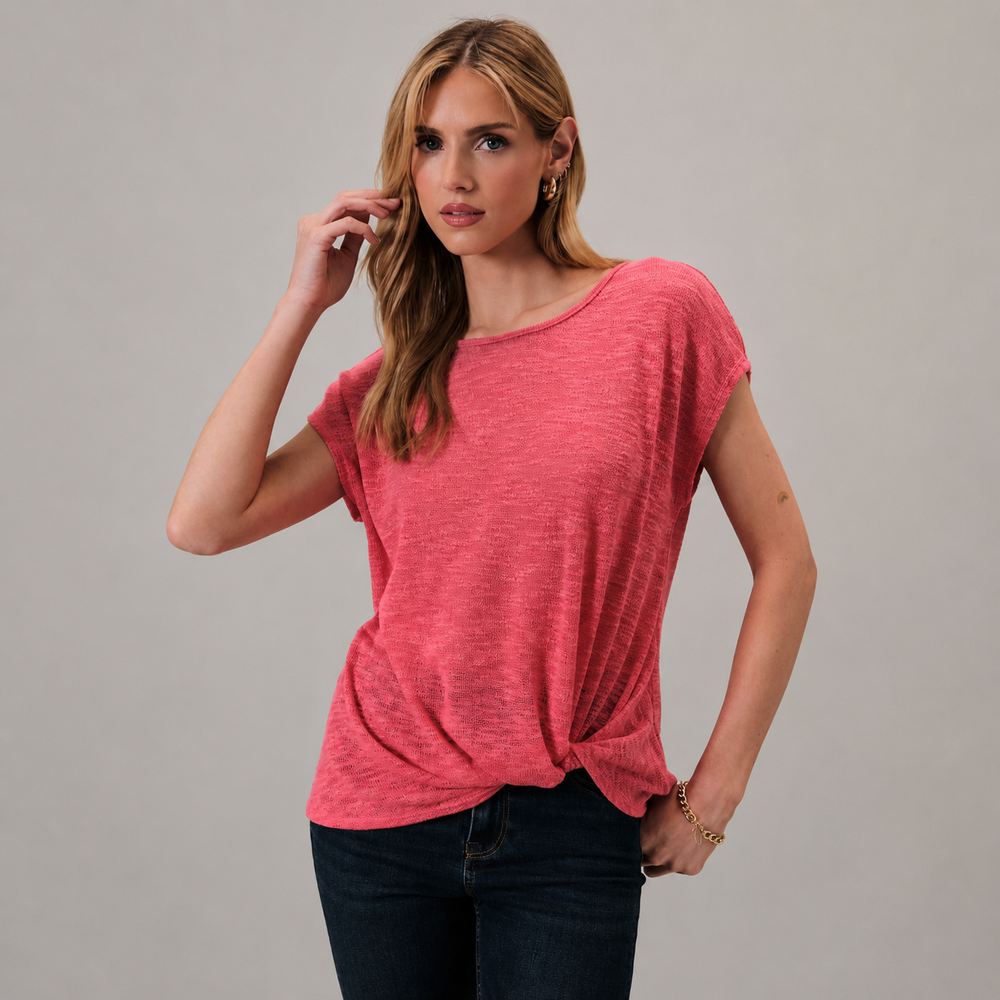 Woman wearing a pink t-shirt against a gray background
