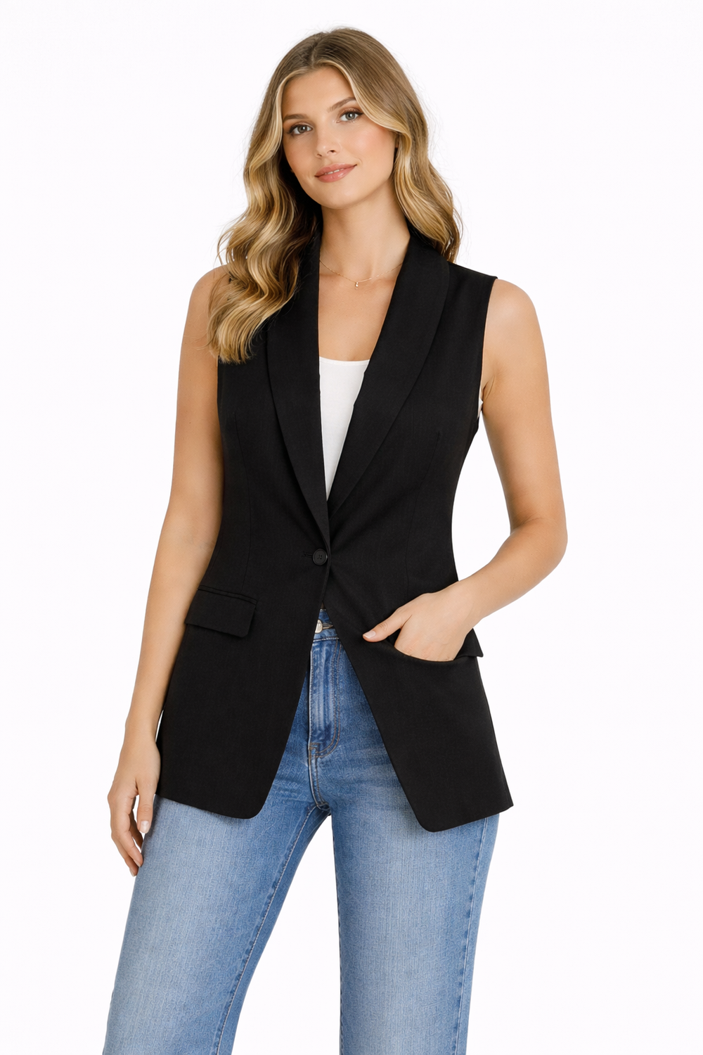 Woman wearing a black sleeveless blazer and blue jeans on a white background