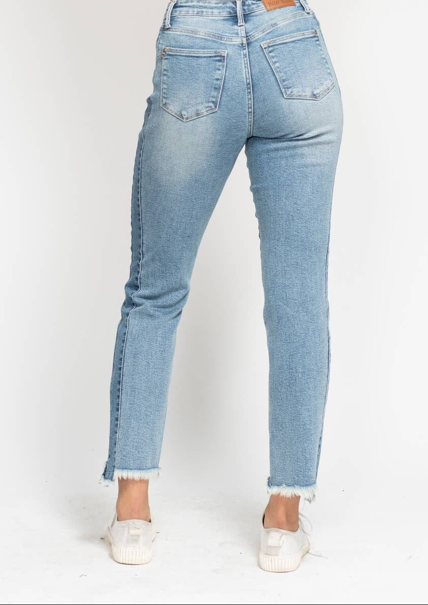 Light blue jeans worn by a person on a white background