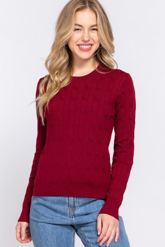 Woman wearing a red sweater and blue jeans on a white background