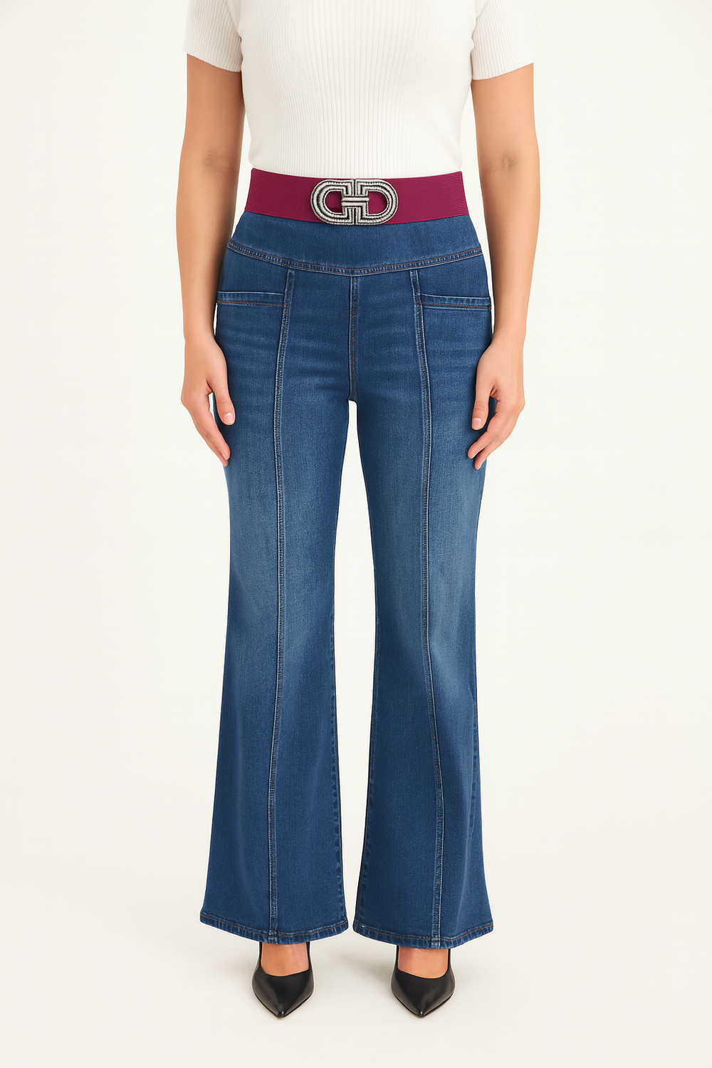 Person wearing blue flared jeans with a wine belt on a white background