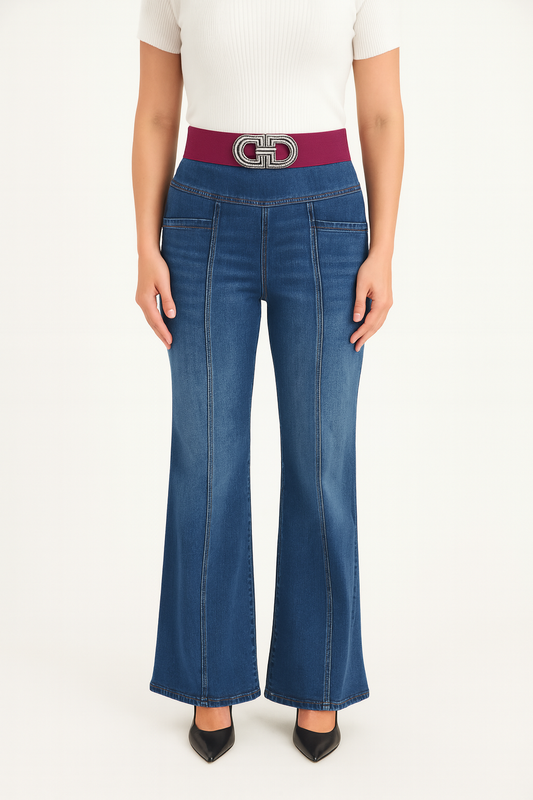 Person wearing blue flared jeans with a wine belt on a white background