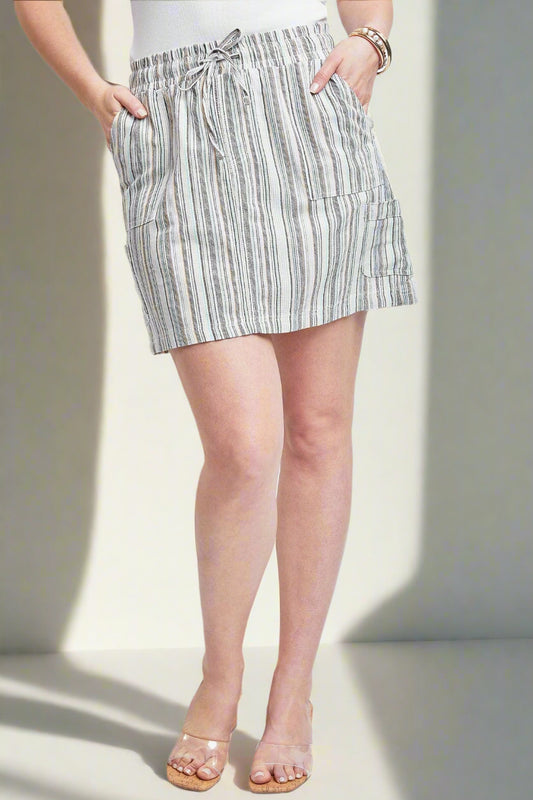 Person wearing a striped skirt on a plain background