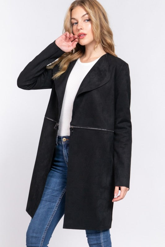 Woman wearing a black coat with leather accents on a white background