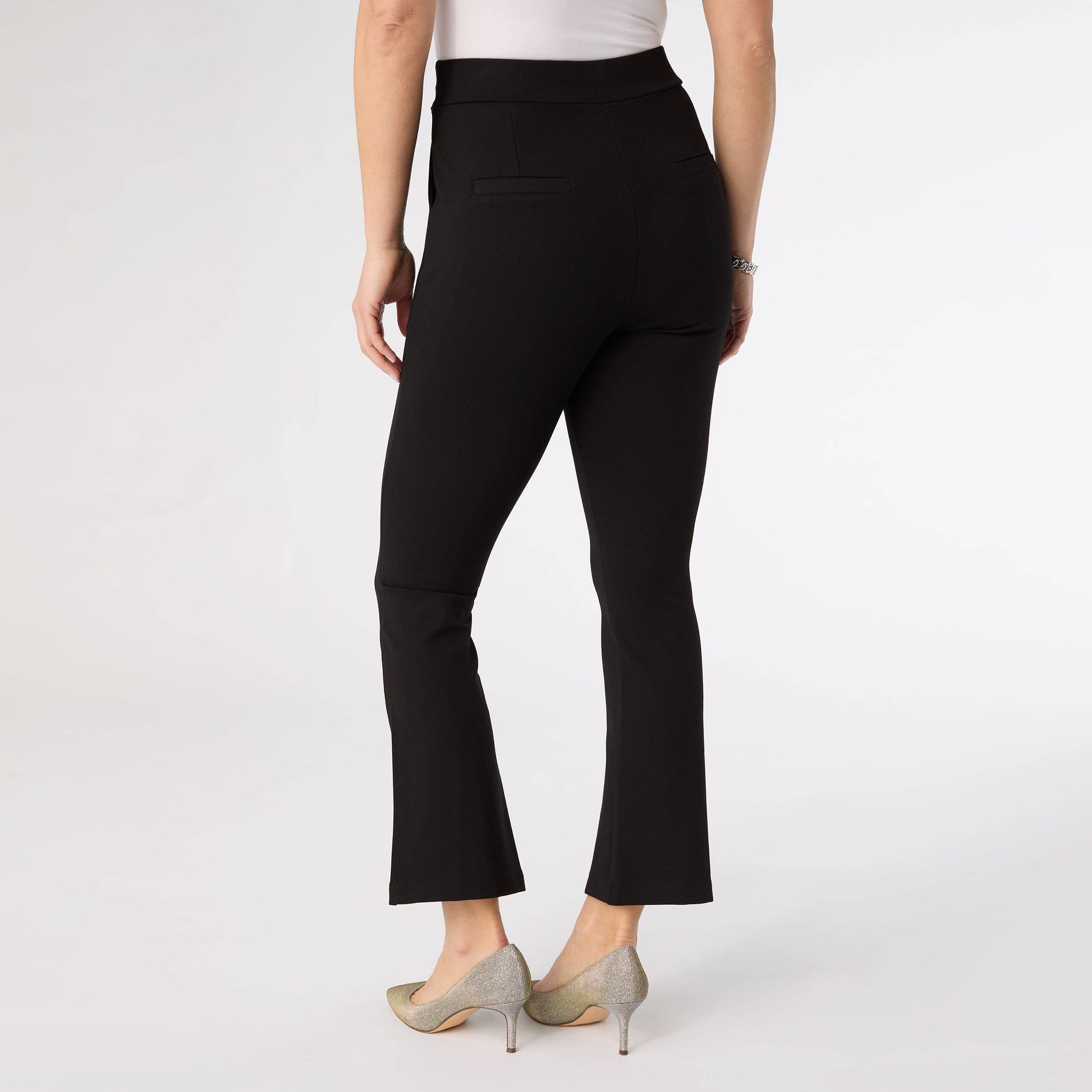 Black pants worn by a person on a white background