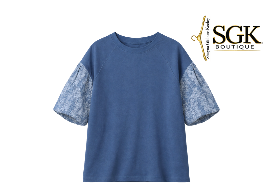 Blue shirt with patterned sleeves on a white background, featuring the SGK Boutique logo.
