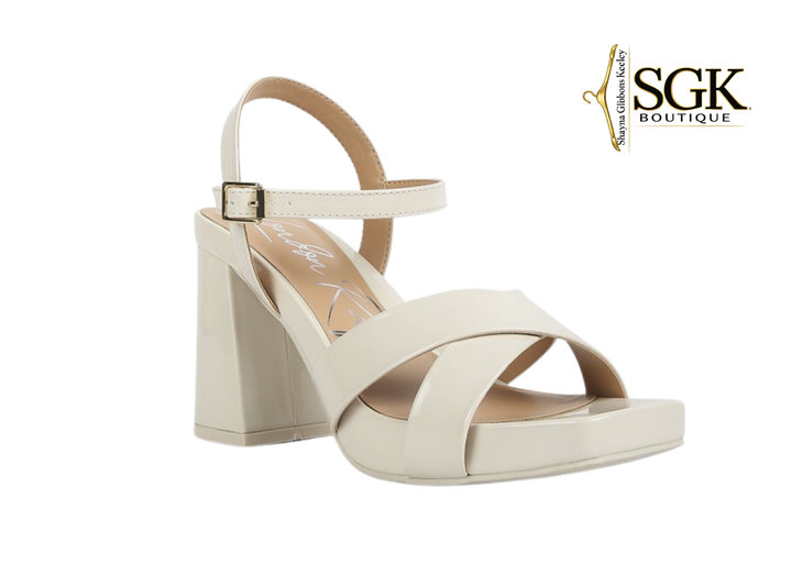 White sandal with block heel on a white background, featuring SGK Boutique logo.