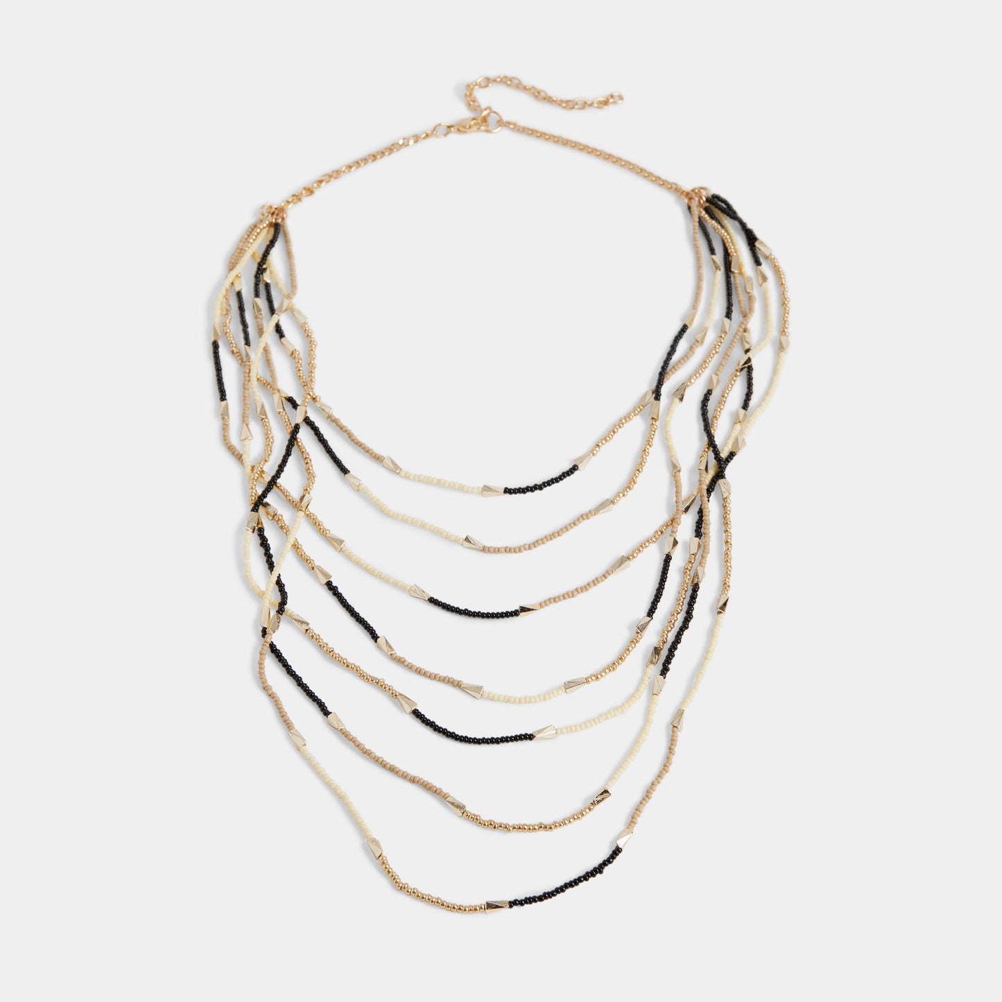 Layered necklace with gold and black strands on a white background