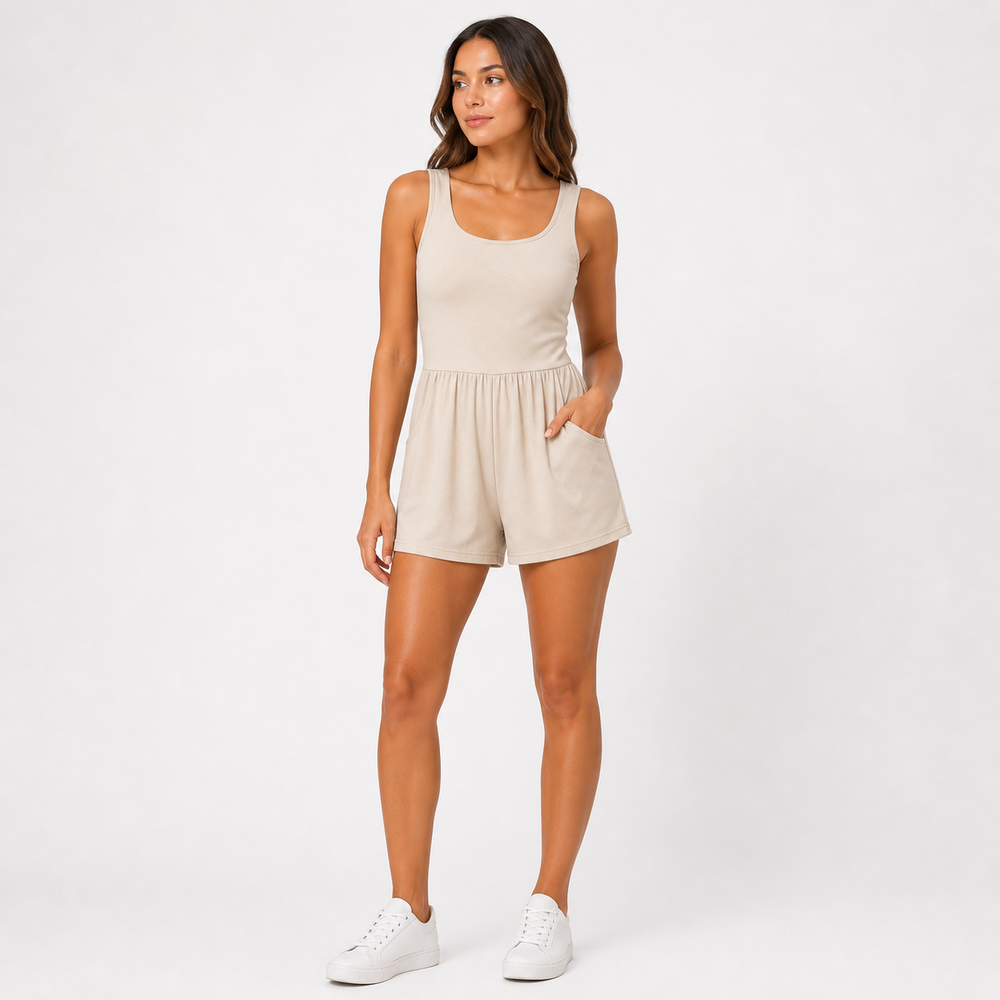 Woman wearing a beige romper on a white background