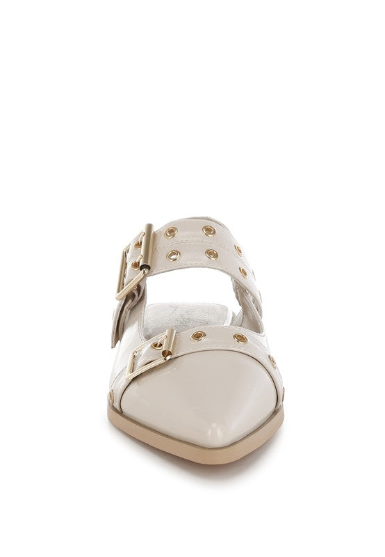 White sandal with gold accents on a white background
