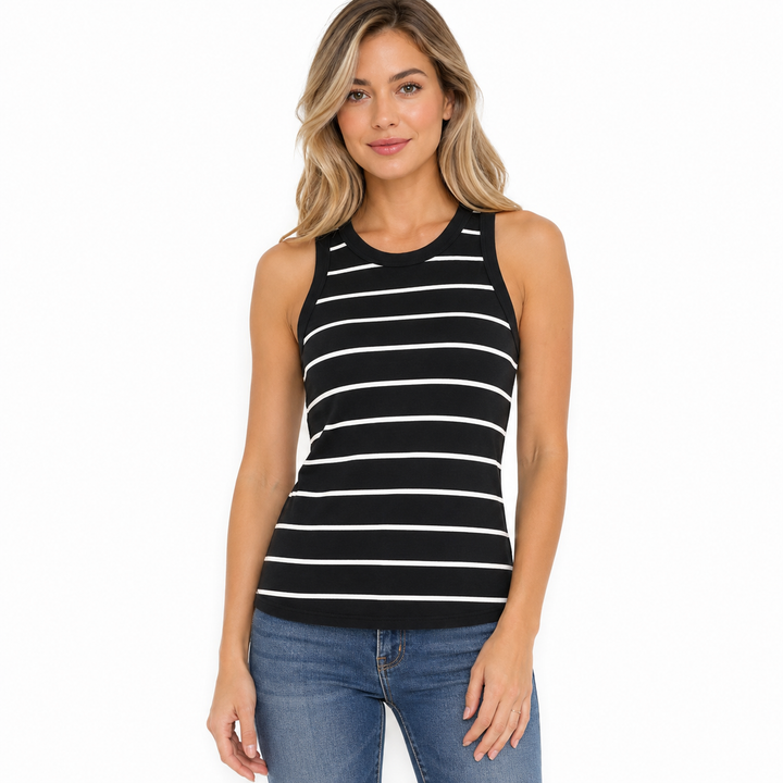 A woman modeling a sleeveless black tank top with thin white horizontal stripes, paired with blue jeans, against a plain white background.