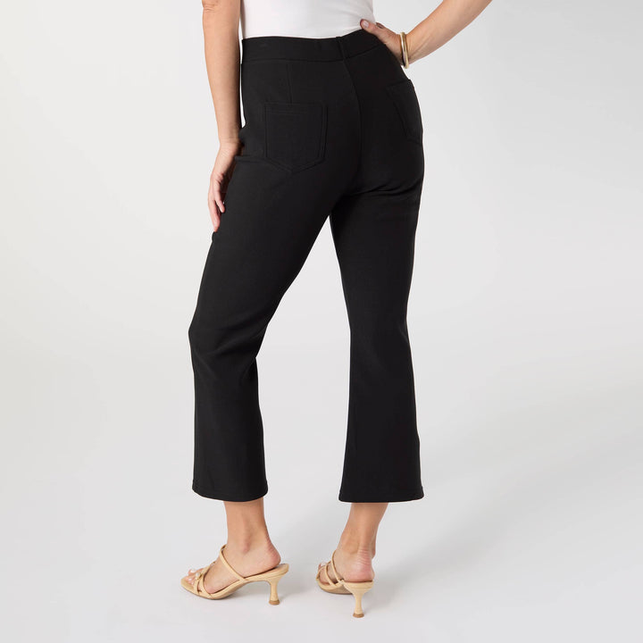 Person wearing black pants on a white background