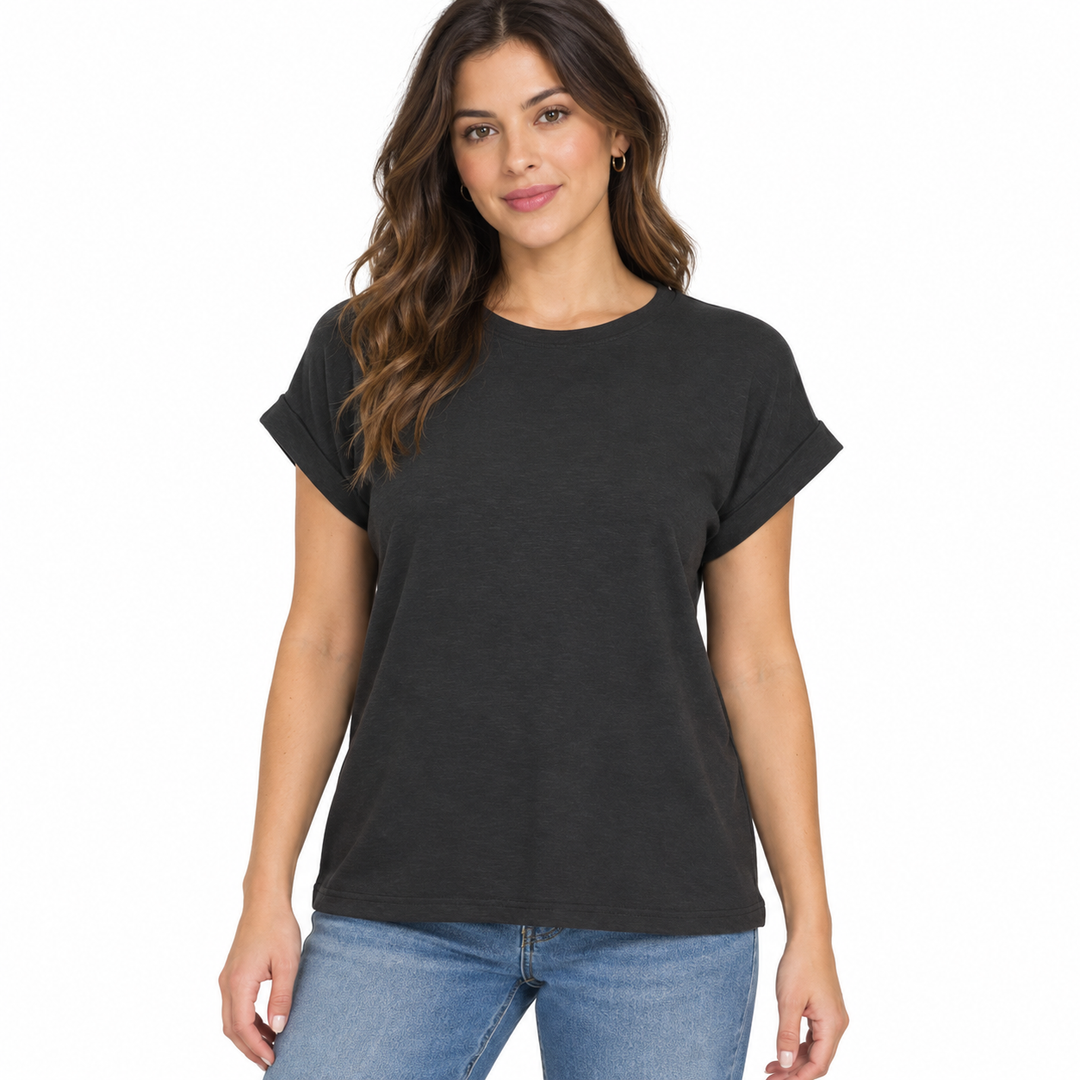 A woman modeling a black short-sleeve t-shirt with rolled cuffs, paired with blue jeans, against a plain white background.