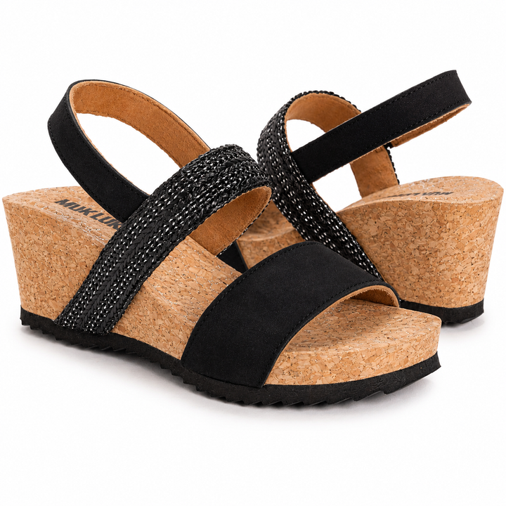 Black wedge sandals with cork sole on a white background