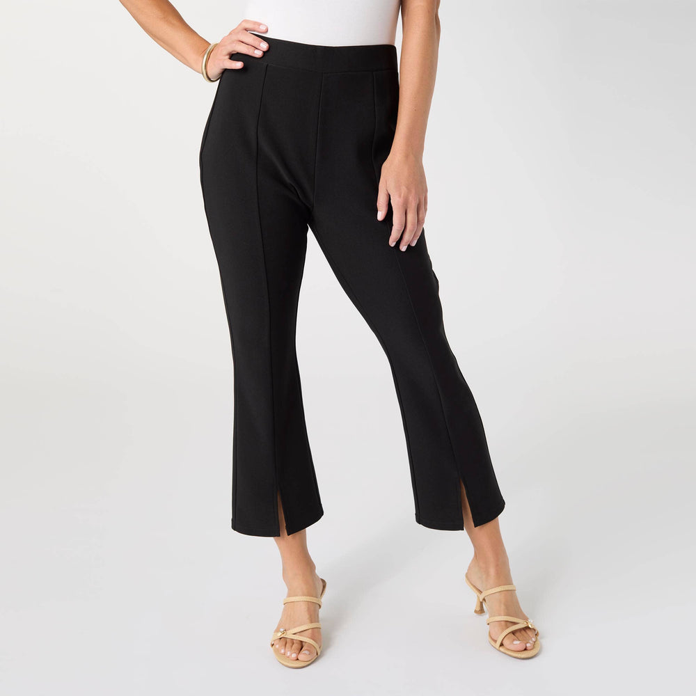 Black capri pants worn by a person on a white background
