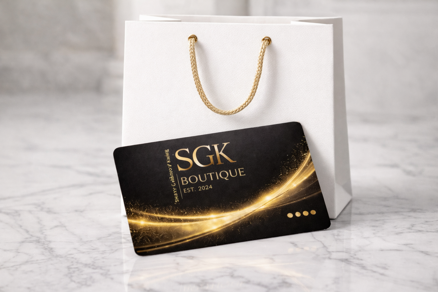 SGK Boutique gift card on a white shopping bag with gold accents