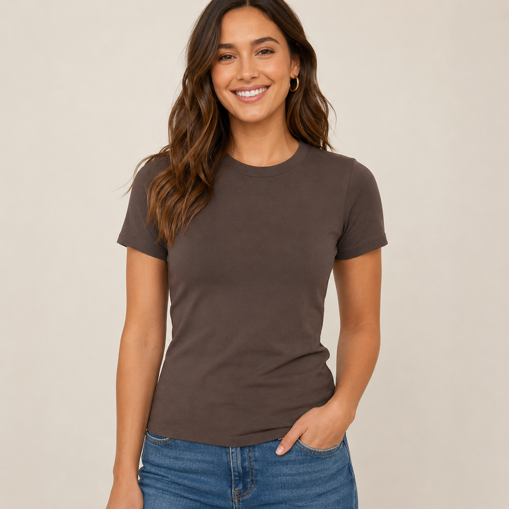 Woman wearing a brown t-shirt and blue jeans against a beige background