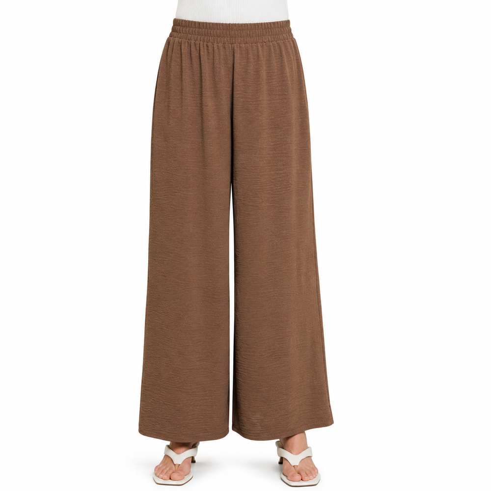 A pair of wide-leg cropped pants in a warm brown color, shown on a model from the waist down wearing white sandals against a plain white background.