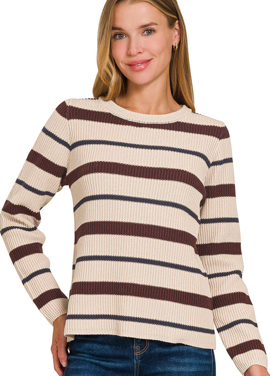 Woman wearing a striped sweater with brown and beige colors on a white background