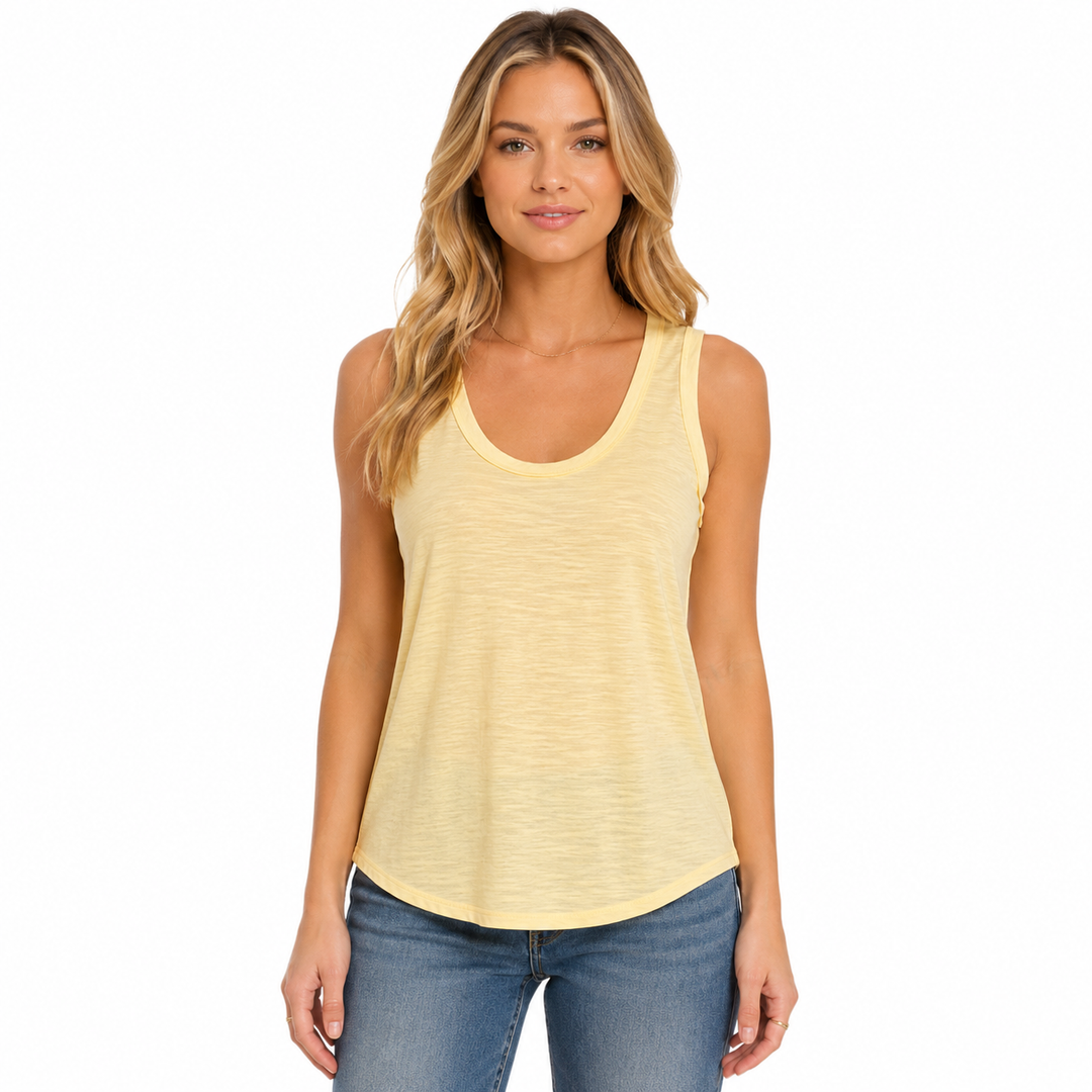 A woman modeling a pale yellow heathered sleeveless tank top with blue jeans against a plain white background.