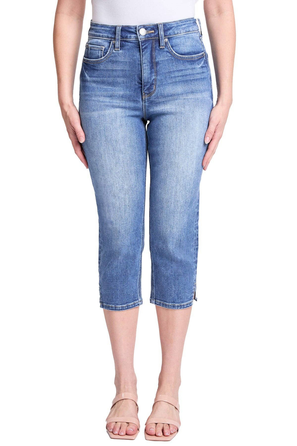 Blue jeans worn by a person on a white background