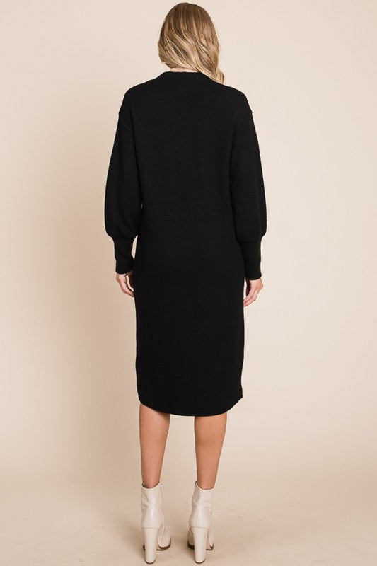 Person wearing a black dress against a beige background