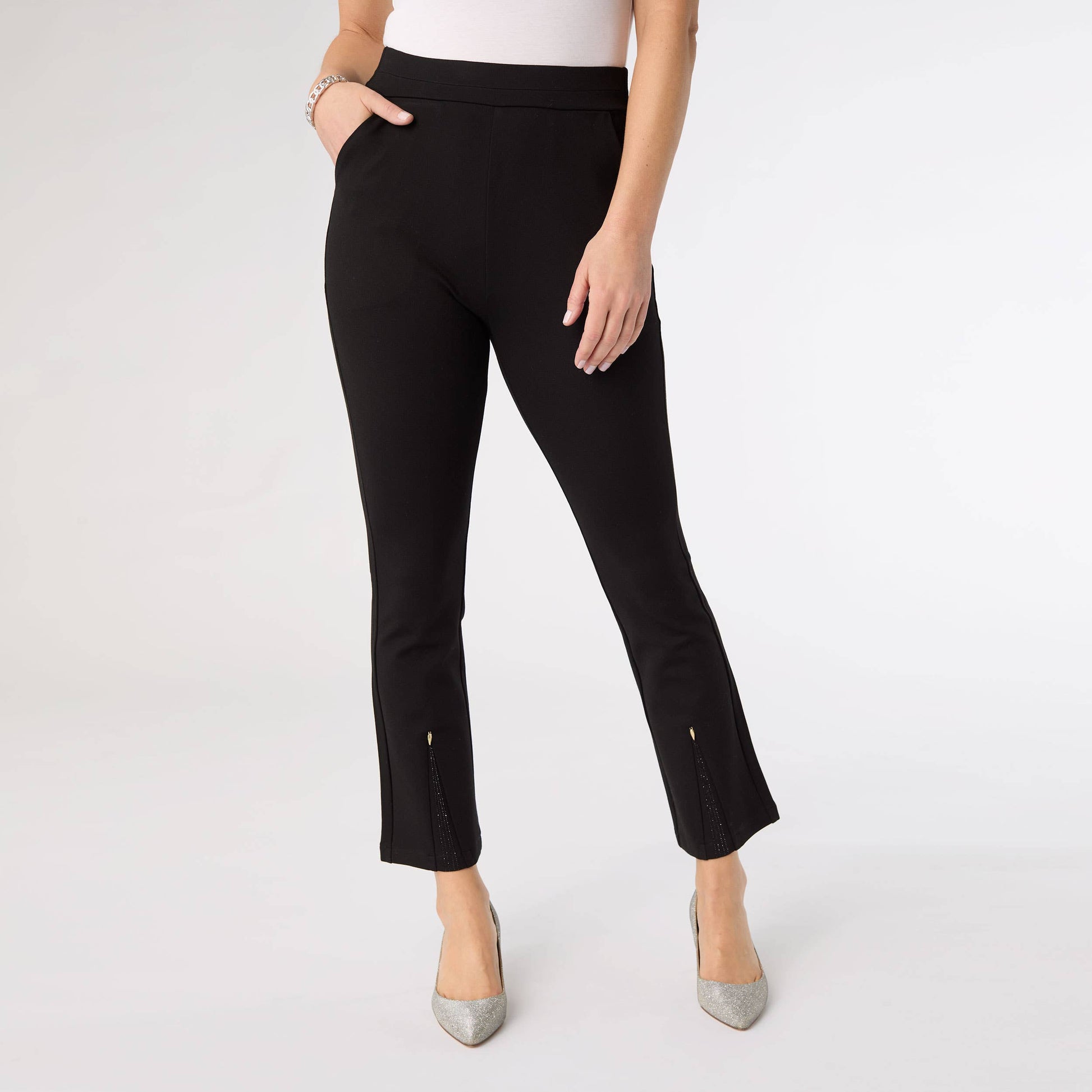 Black pants worn by a person on a white background