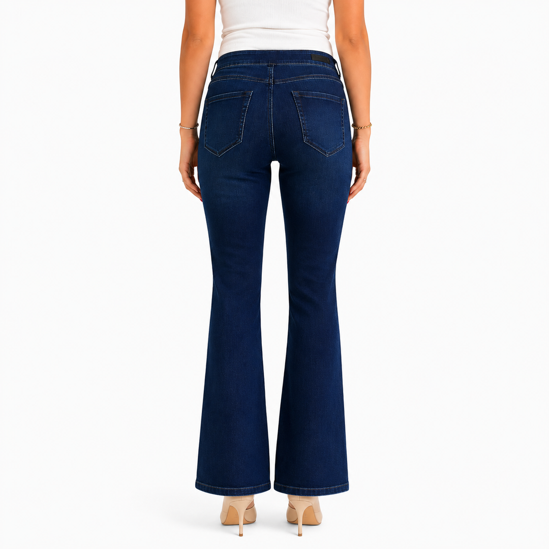 A model shown from the back wearing dark blue flare jeans, a white top, and beige heels against a plain white background.