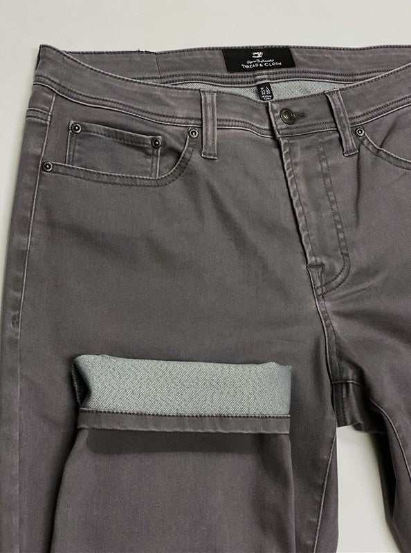 Gray pants with a visible brand label on a light gray background