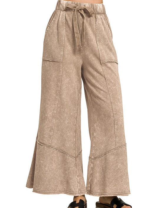 Beige wide-leg pants with a tie waist on a white background