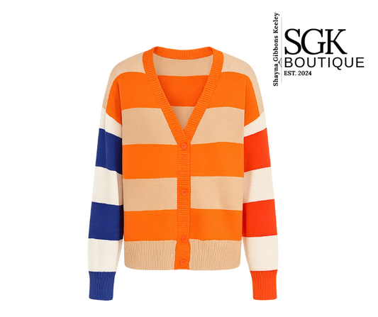 Color-blocked cardigan with orange, beige, blue, and white stripes on a white background, featuring SGK Boutique logo.