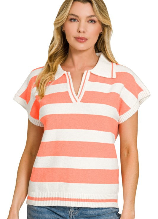Woman wearing a coral and white striped shirt with blue jeans on a white background