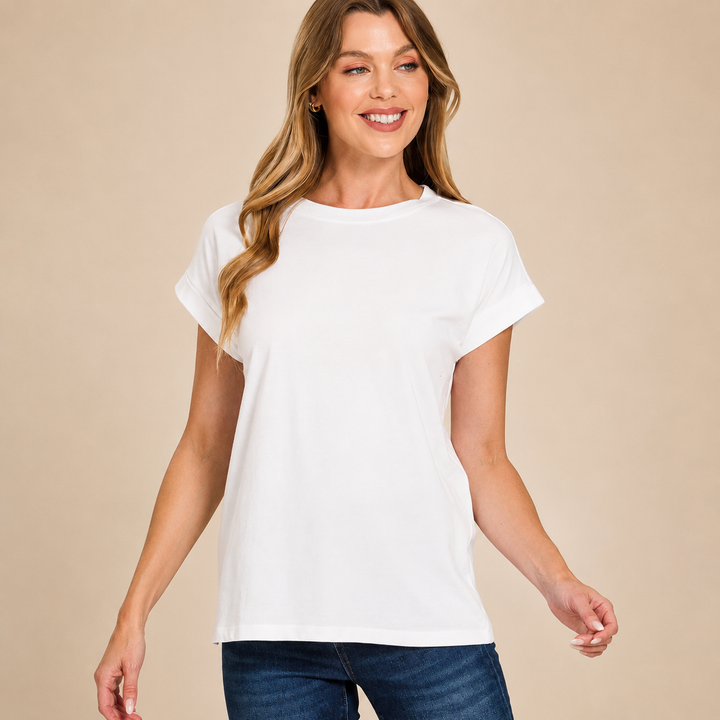 Woman wearing a plain white t-shirt against a beige background