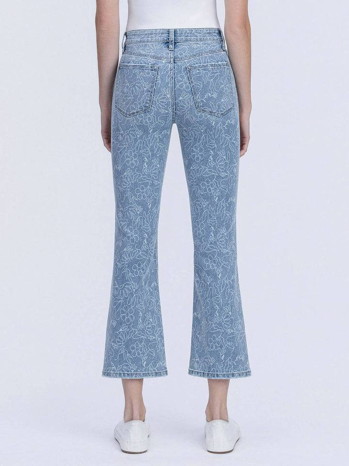 Light blue floral-patterned jeans worn by a person on a white background