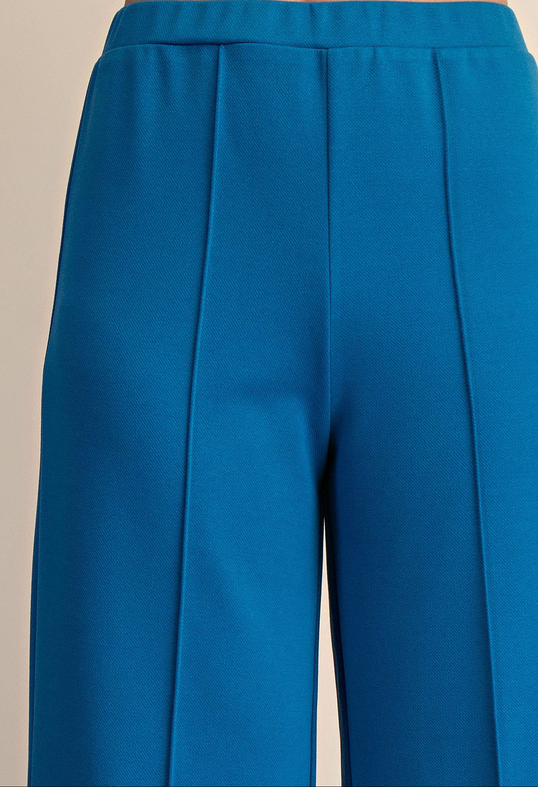 Blue pants with a beige background