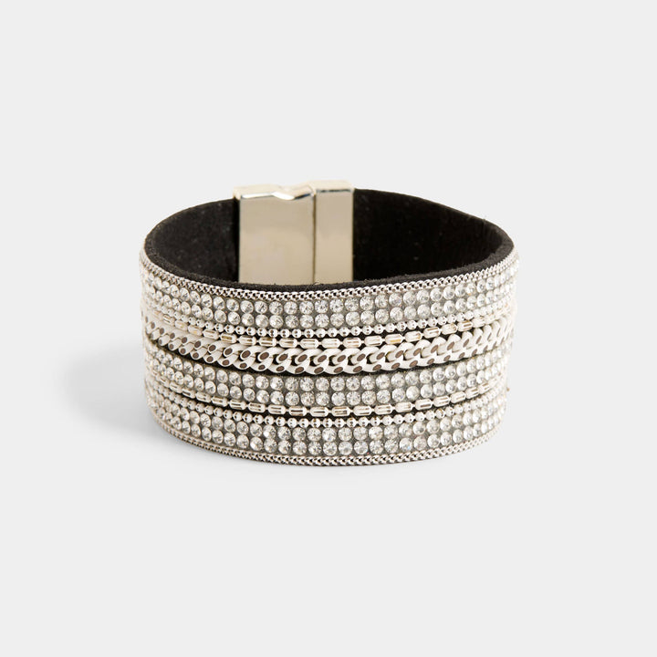 Multilayered bracelet with metallic beads on a light gray background