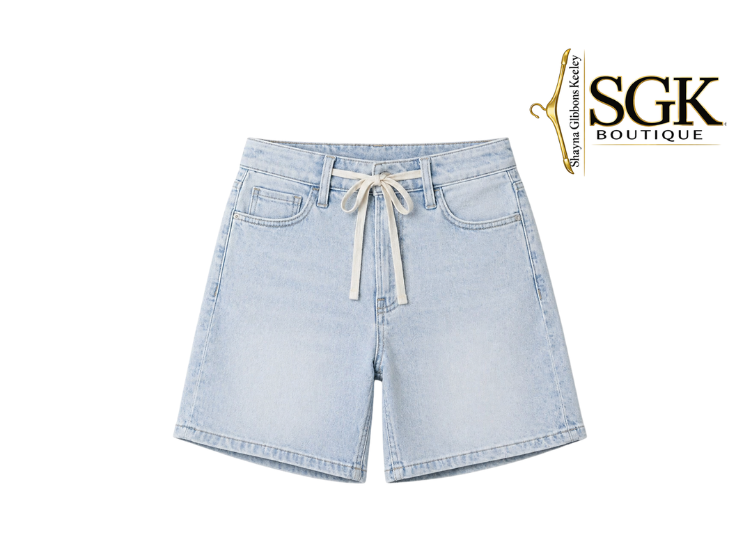 Light blue denim shorts with a drawstring on a white background, featuring the SGK Boutique logo.