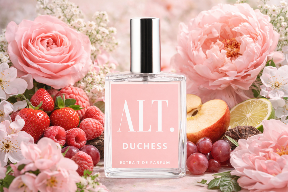 Perfume bottle labeled 'ALT. Duchess' surrounded by pink flowers and fruits on a light background