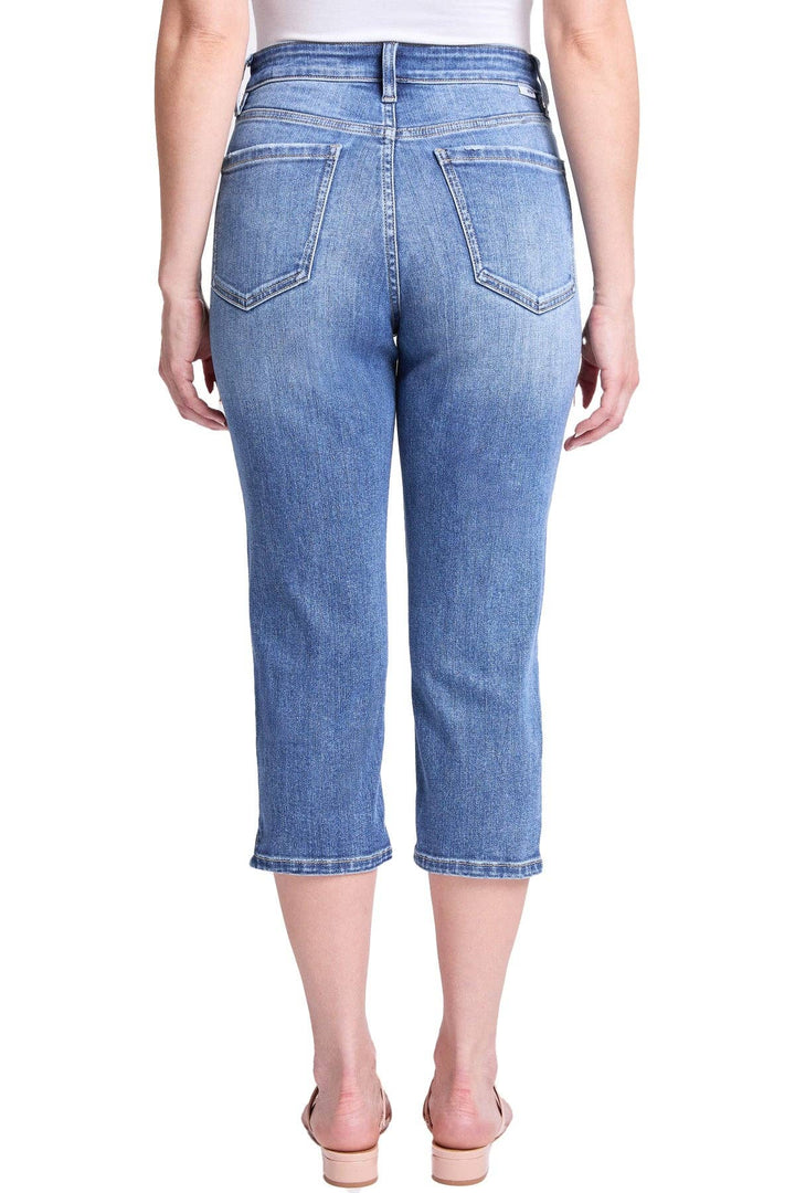 Person wearing blue jeans on a white background