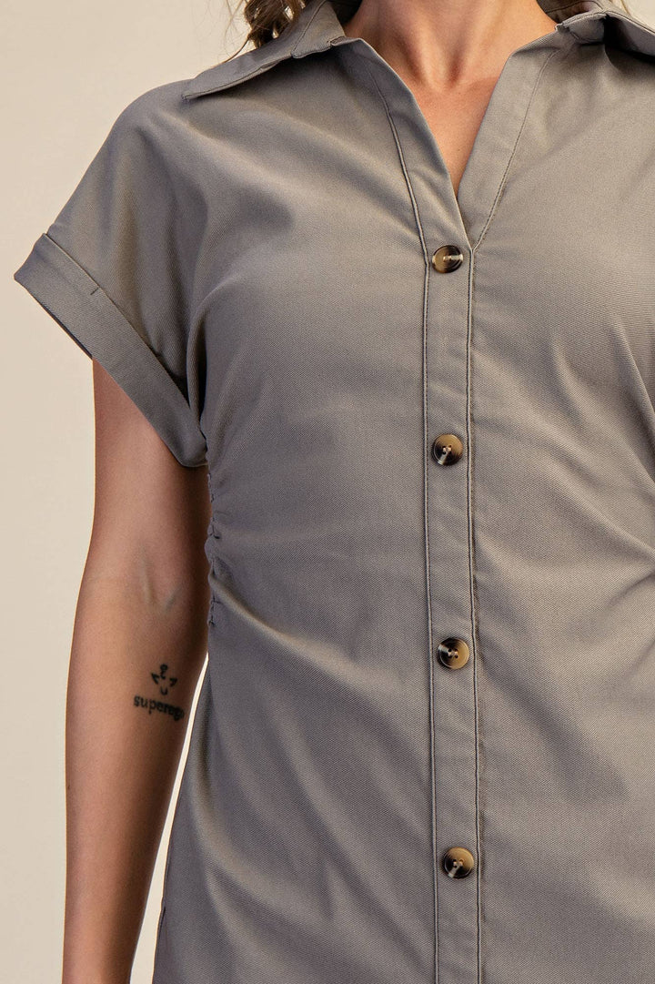 Fatigue short-sleeve shirt with buttons on a beige background