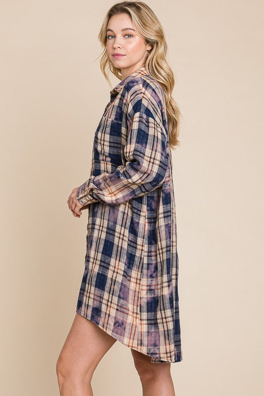 Woman wearing a plaid dress against a beige background