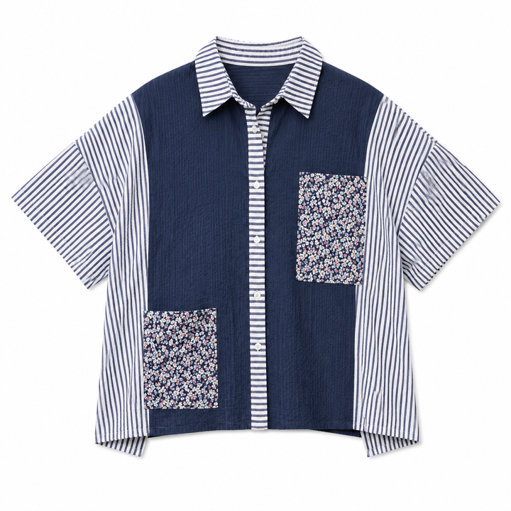 Navy and white striped shirt with floral pocket on a white background