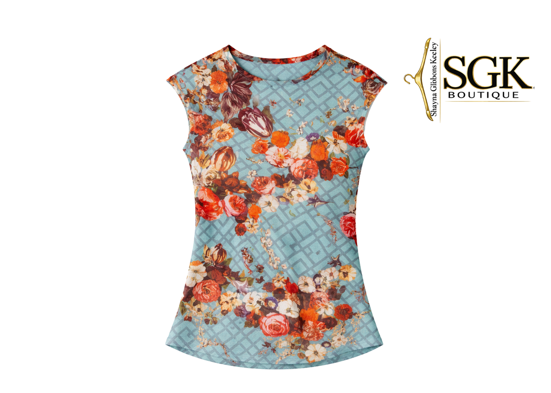 Floral patterned dress on a light blue background with SGK Boutique logo.