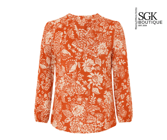 Orange floral patterned blouse on a white background with SGK Boutique logo.
