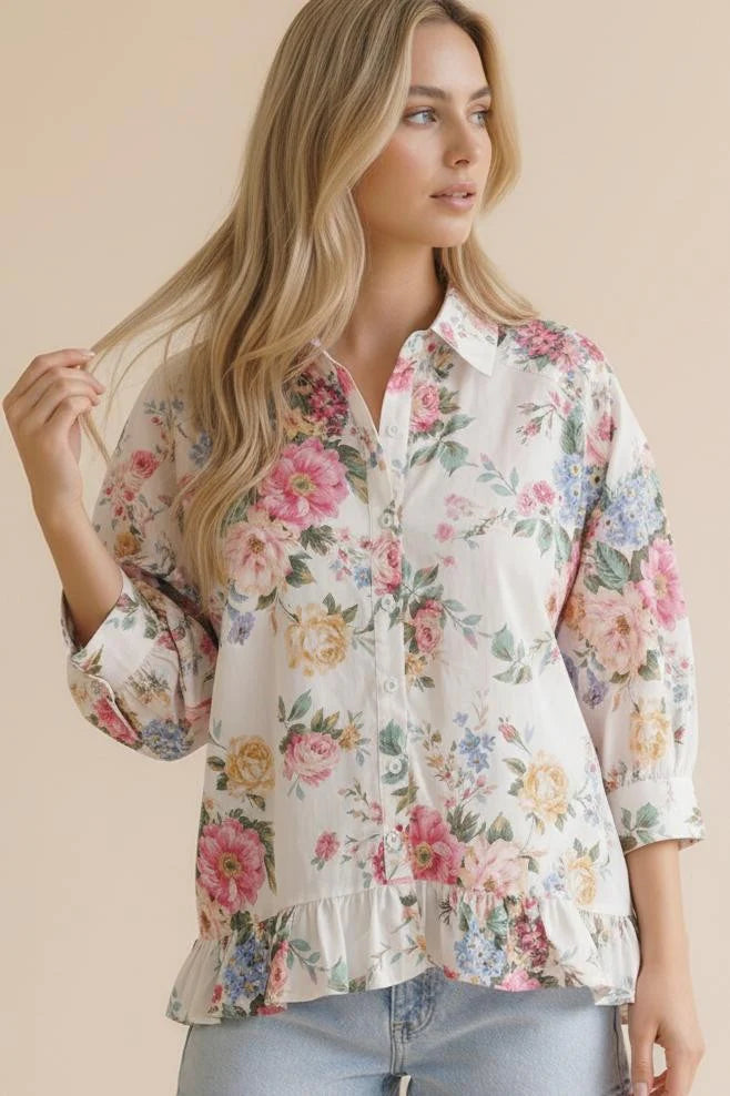 Woman wearing a floral blouse with a beige background