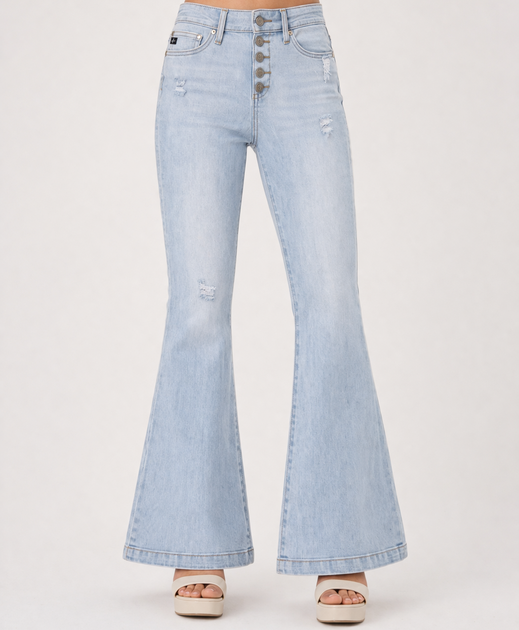 Light blue flared jeans on a white background